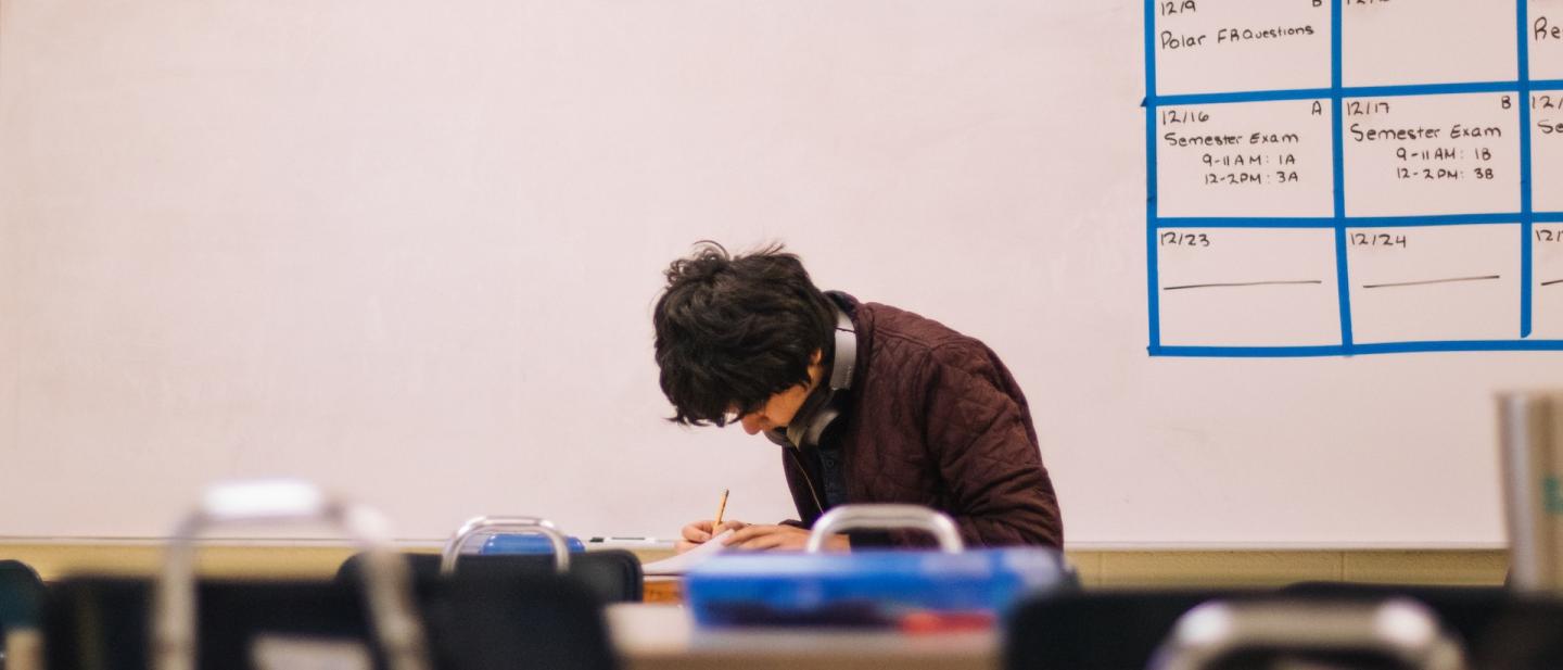 Student working on his work alone in class